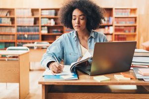 Young woman in a library studying