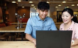 male student at laptop with teacher