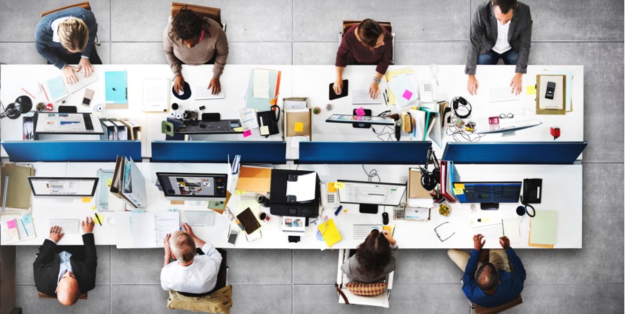 picture from above of a group of people working on a desk